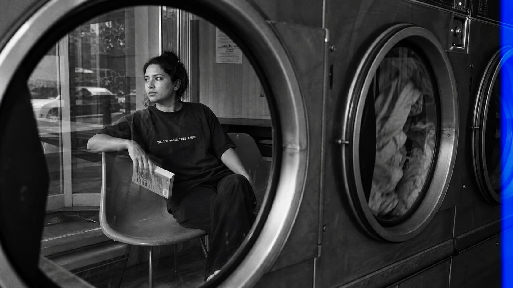 A woman wearing the You’re absolutely right. tee in a laundromat